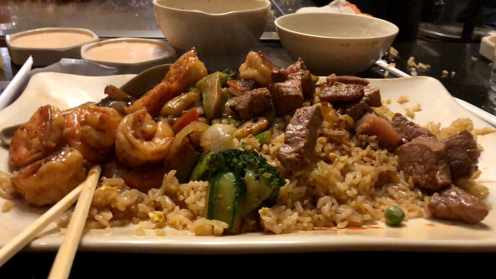 Dinner is the show at Osaka Japanese Steakhouse in Beavercreek near Dayton. The restaurant's  dinning room has several hibachi tables. Sushi and other Japanese favors are on the menu.  The walls are covered in hundreds of photos of customers celebrating anniversaries and birthdays.