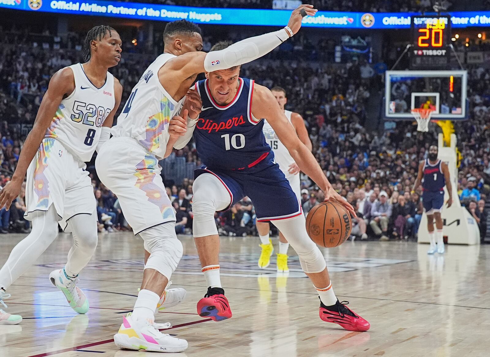 Los Angeles Clippers guard Bogdan Bogdanovic, right, struggles to drive to the basket as Denver Nuggets guard Russell Westbrook defends in the second half of Game 5 of an NBA basketball playoff series Tuesday, April 29, 2025, in Denver. (AP Photo/David Zalubowski)