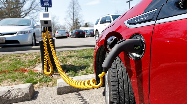 A Chevy Volt is hooked to an electric vehicle charging station on Miami University’s campus in this file photo.
