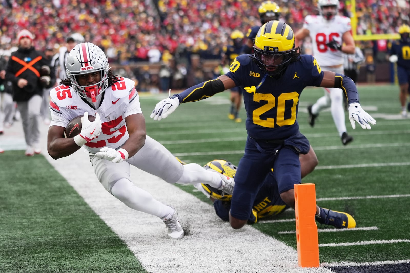 Ohio State running back Bo Jackson, left, is tackled out of bounds by Michigan defensive back Jyaire Hill during the first half of an NCAA college football game, Saturday, Nov. 29, 2025, in Ann Arbor, Mich. (AP Photo/Ryan Sun)