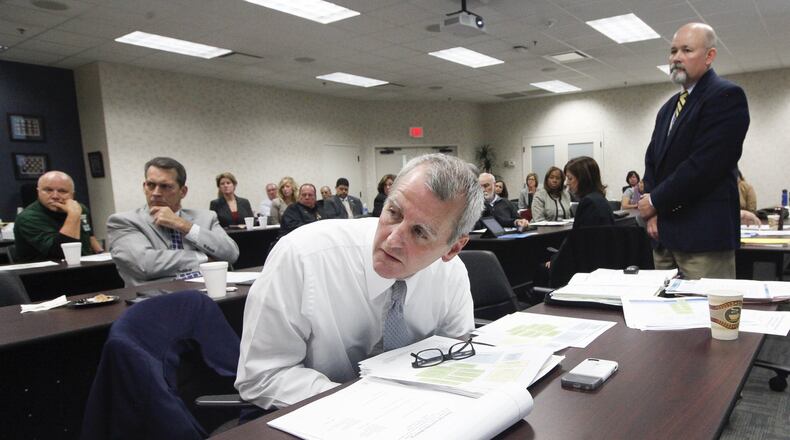 Montgomery County Commissioner Dan Foley, center, and Jeff Cooper, right, Montgomery County health commissioner, listen during a meeting by a steering committee of a new Community Overdose Action Team response to the heroin crisis. CHRIS STEWART / STAFF