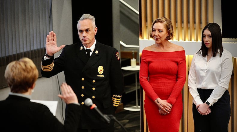Dayton Fire Department's new chief, Mike Rice, was sworn in by Dayton City Manager Shelley Dickstein on Monday, Feb. 5, 2024. Chief Rice's wife, Robbie, and daughter Liv also attended the ceremony. MARSHALL GORBY \STAFF