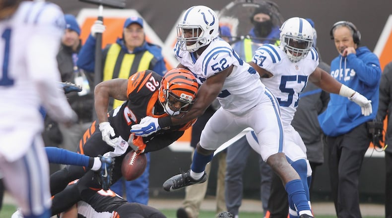 CINCINNATI, OH - OCTOBER 29: Barkevious Mingo #52 of the Indianapolis Colts strips the football from Joe Mixon #28 of the Cincinnati Bengals during their game at Paul Brown Stadium on October 29, 2017 in Cincinnati, Ohio. The Bengals defeated the Colts 24-23. (Photo by John Grieshop/Getty Images)