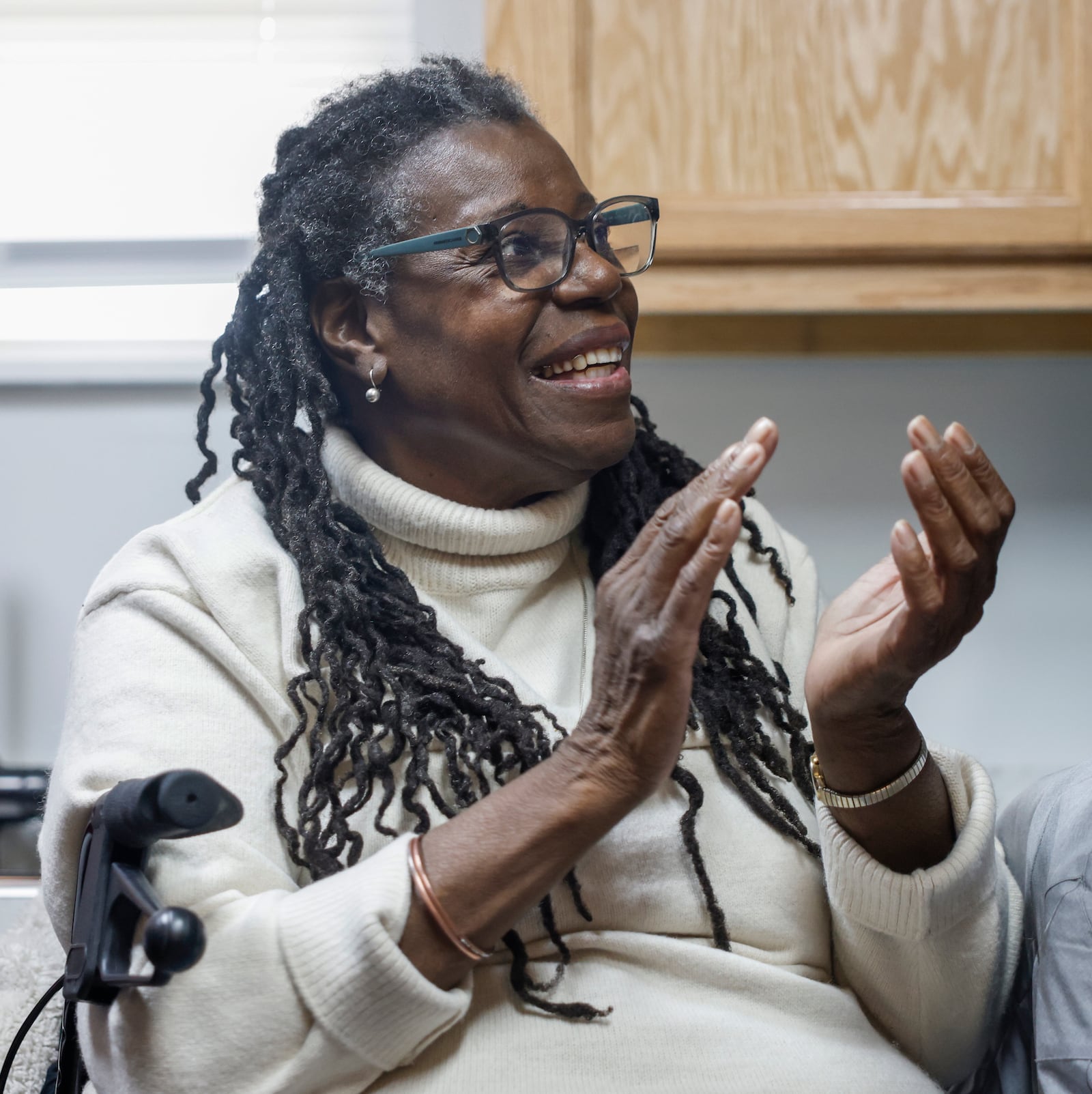 Gwendolyn Iheme cheers as she's acknowledged during a home dedication hosted by the Habitat for Humanity of Greater Dayton on Friday, Dec. 12, 2025, in Springfield. The ceremony was for Iheme, who will live in the house with her 8-year-old granddaughter Rileyanna Foster. JOSEPH COOKE/STAFF
