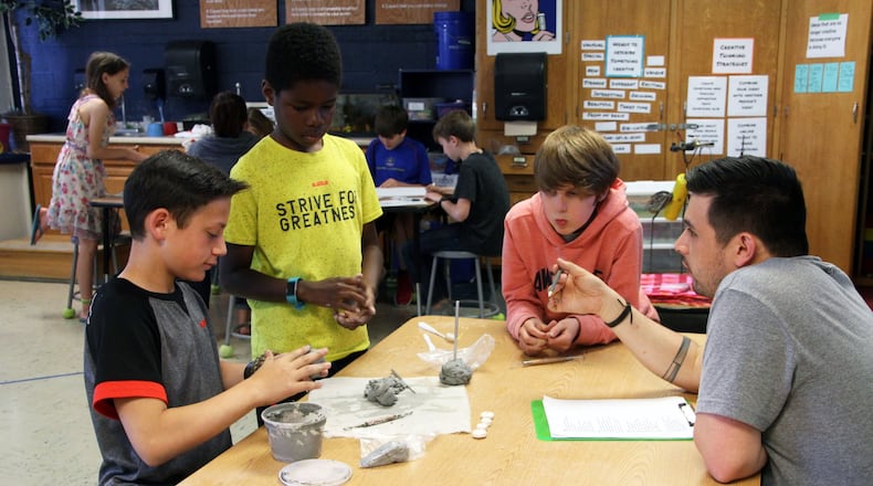 Matthew Szozda, an art teacher at W.O. Cline Elementary in Centerville, works with fifth-graders last school year. Szozda is one of 11 educators named a “2020 Teacher of the Year” by the Ohio Department of Education. CONTRIBUTED PHOTO