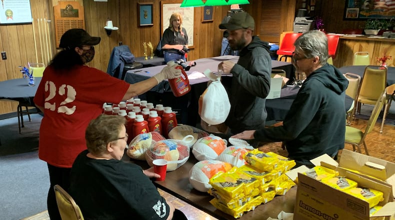 Volunteers at the Veterans of Foreign Wars Post 9936 on East Third Street in Dayton give away donated turkeys and other Thanksgiving fixings to area veterans.