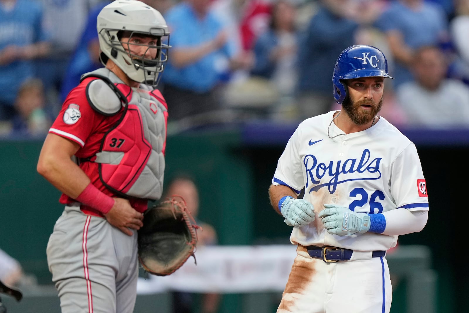 Kansas City Royals' John Rave crosses the plate past Cincinnati Reds catcher Tyler Stephenson to score on double by Bobby Witt Jr. during the fifth inning of a baseball game Wednesday, May 28, 2025, in Kansas City, Mo. (AP Photo/Charlie Riedel)