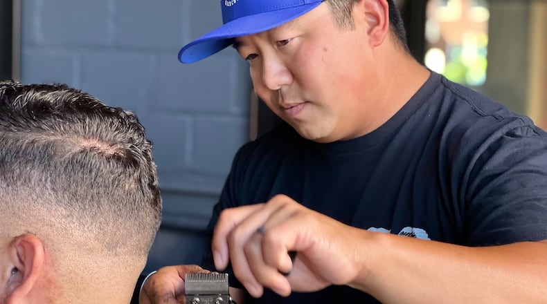 Army veteran Rylan Williams opened up his barbershop in downtown Dayton earlier this year. AIMEE HANCOCK/STAFF