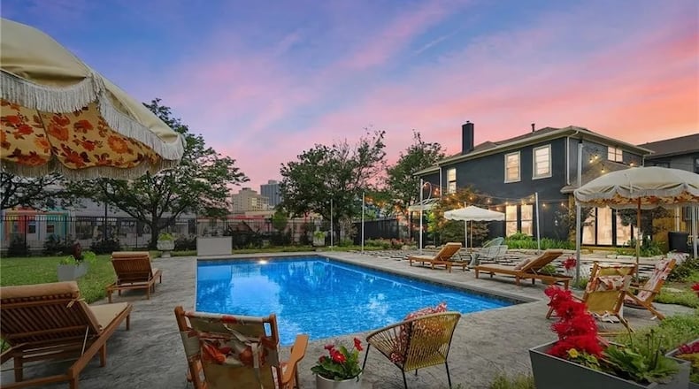 On the market for $950,000, this spacious 1890 home at 368 S. Patterson Blvd. in Dayton has been fabulously reimagined with colorful and modern accents throughout. The house seamlessly combines various architectural styles, including Victorian, Art Deco and Mid-Century Modern. From the Gucci wallpaper to the Jonathan Adler light fixtures, the home is a canvas of artistic expression. An outdoor heated swimming pool and patio are also highlights of the property, which is in the Oregon District. PHOTOS COURTESY OF DAYTON REALTORS. To see more home listings, visit DaytonDailyNews.com/home