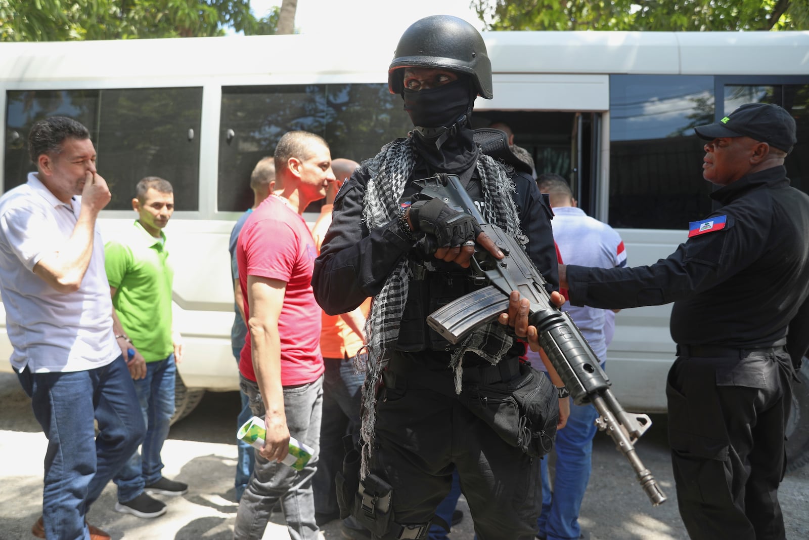 Colombians and Haitians who are accused of involvement in the 2021 assassination of Haitian President Jovenel Moise are escorted in handcuffs after the court hearing in Port-au-Prince, Haiti, Monday, May 26, 2025. (AP Photo/Odelyn Joseph)
