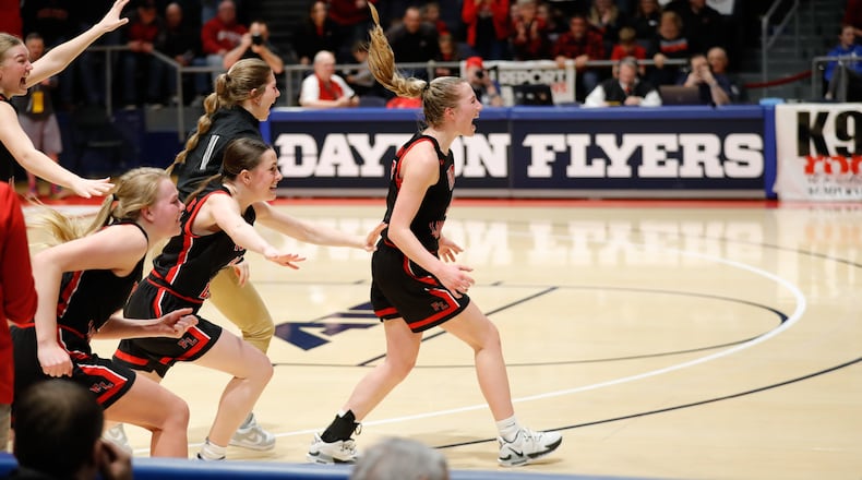 The Fort Loramie High School girls basketball team celebrates after beating Waterford in the Division IV state championship game at UD Arena last season. Michael Cooper/CONTRIBUTED