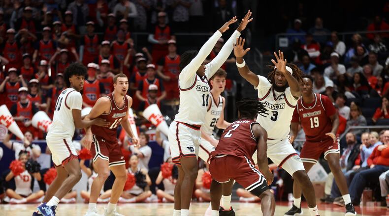 Dayton's Malachi Smith and Jaiun Simon apply pressure against New Mexico State on Wednesday, Nov. 20, 2024, at UD Arena. David Jablonski/Staff