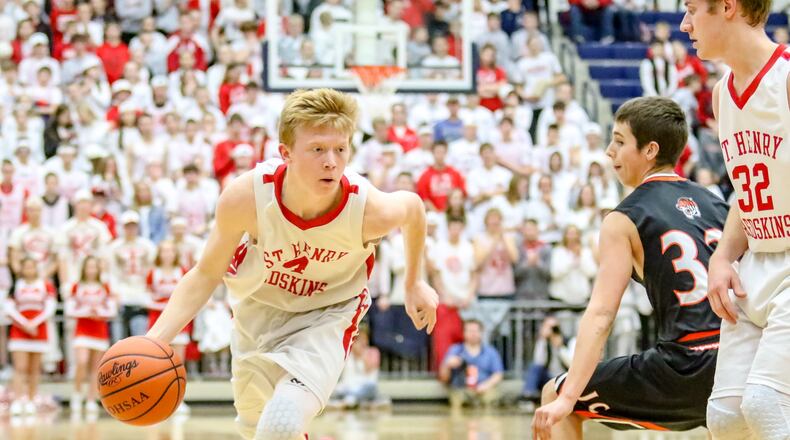 St. Henry s Andrew Lange drives to the hoop against Jackson Center s Trevor Sosby during a Division IV regional final game on Friday night at Fairmont High School s Trent Arena. The Redskins won 46-43 to advance to the state final four. CONTRIBUTED PHOTO BY MICHAEL COOPER