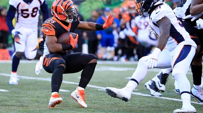 CINCINNATI, OH - DECEMBER 2: Giovani Bernard #25 of the Cincinnati Bengals attempts to run the ball past Todd Davis #51 of the Denver Broncos during the third quarter at Paul Brown Stadium on December 2, 2018 in Cincinnati, Ohio. (Photo by Andy Lyons/Getty Images)
