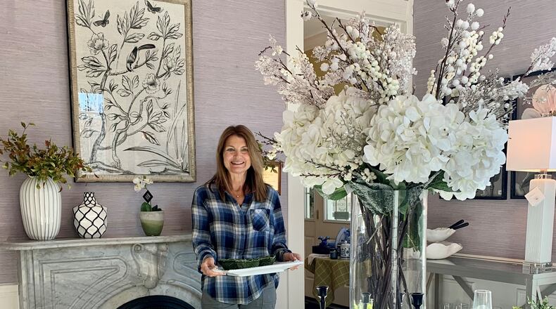 Kim Howell is one of 80 volunteers who contribute time to The Little Exchange. Here, she is pictured in the shop’s dining room. CONTRIBUTED