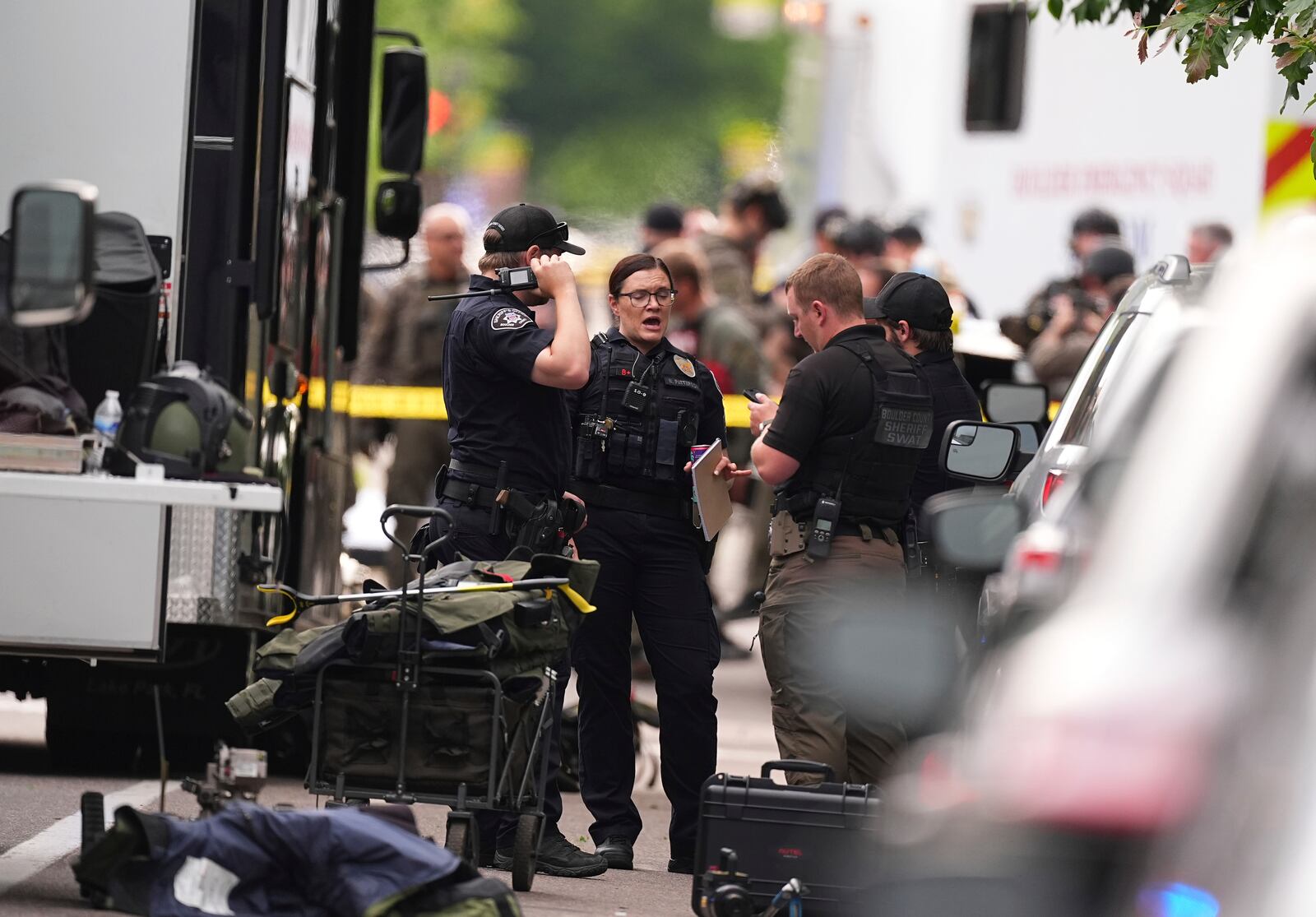 Law enforcement officials investigate after an attack on the Pearl Street Mall Sunday, June 1, 2025, in Boulder, Colo. (AP Photo/David Zalubowski)