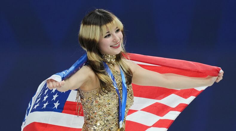 Gold medalist Alysa Liu of the United States celebrates her medal after competing in the women's free skate program in figure skating at the 2026 Winter Olympics, in Milan, Italy, Thursday, Feb. 19, 2026. (AP Photo/Stephanie Scarbrough)