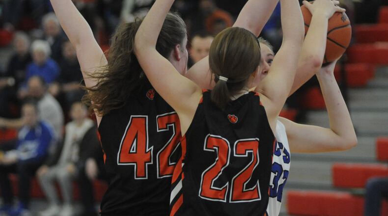 Cincinnati Christian’s Grace Edmonston (with ball) has her path blocked by Jackson Center’s Alicia Kessler (42) and Kamryn Elchert (22) during Saturday afternoon’s Division IV district final at Troy. MARC PENDLETON/STAFF