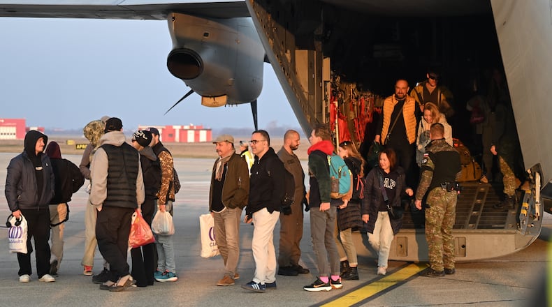 People disembark from a military aircraft as they arrive in Slovakia after being evacuated from the Middle East, Tuesday, March 3, 2026. (Martin Baumann/TASR via AP)