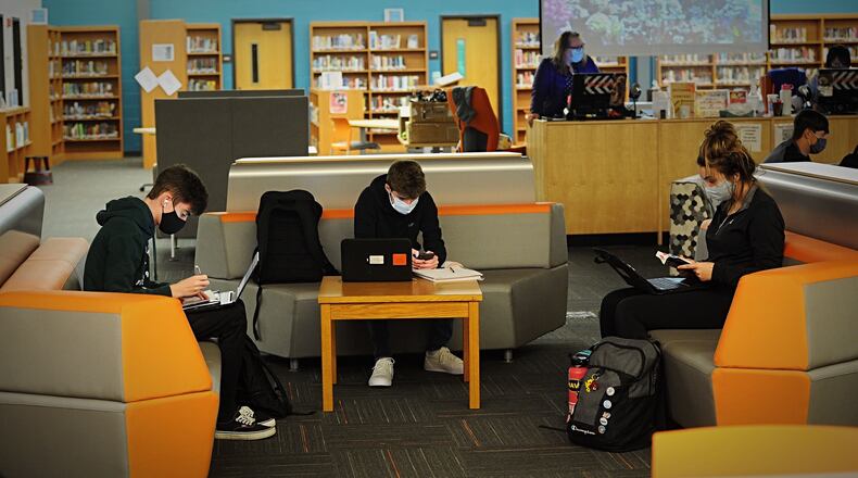 Beavercreek High School students work in the library Thursday, Oct. 8, 2020. Many students' school years have been interrupted by 14-day quarantines when they've been closely exposed to someone with COVID-19.