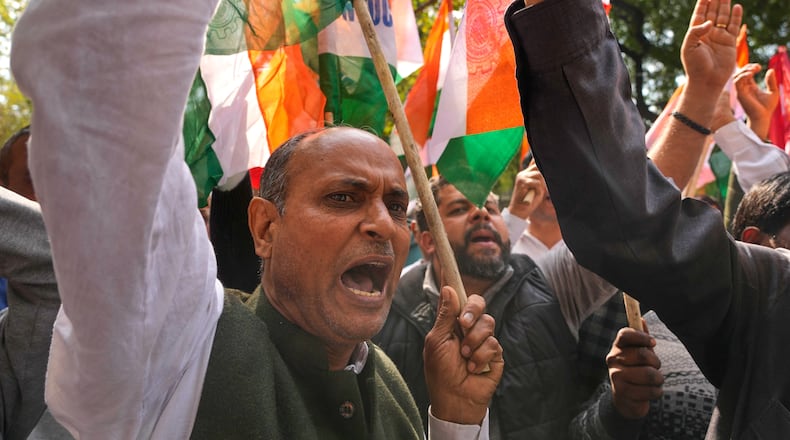 Members of trade unions shout slogans during a nationwide strike to protest an interim trade deal with the United States, saying the agreement undermines the interests of farmers, small businesses and workers in New Delhi, India, Thursday, Feb. 12, 2026. (AP Photo/Manish Swarup)