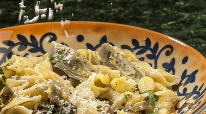 Baby artichokes get a generous dusting of grated Romano cheese in this pasta dish, enriched with cream and enlivened by fresh lemon. (Bill Hogan/Chicago Tribune/TNS)