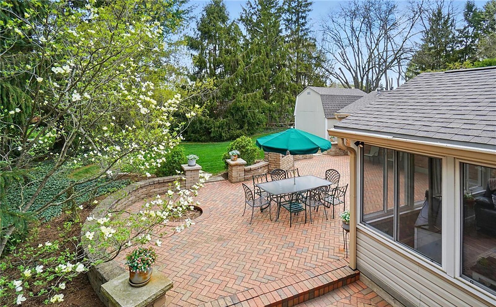 The rear has a multi level brick paver patio with surrounding wall.
