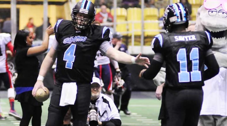 Dayton Sharks quarterback Tommy Jones (4) welcome Evan Sawyer (11) during opening ceremonies during the CIFL Dayton Sharks inaugural home game at Hara Arena against the Port Huron Patriots on Friday evening Feb. 15, 2013.