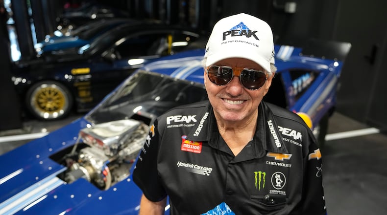 FILE - Drag racing car owner John Force poses next to his original funny car, Aug. 28, 2025, in Zionsville, Ind. (AP Photo/Michael Conroy, File)