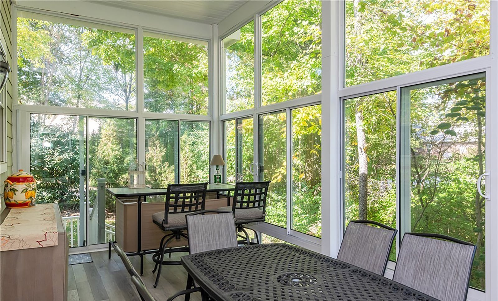 The three seasons room has luxury vinyl tile flooring and overlooks the wooded back yard. CONTRIBUTED