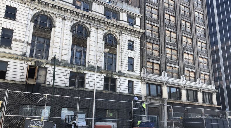 Crews work on the exterior of the southwestern part of the Dayton Arcade complex. CORNELIUS FROLIK / STAFF