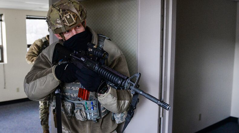 A member of the 88th Security Forces Squadron secures a room during an active-shooter exercise at Wright-Patterson Air Force Base, Ohio, Feb. 24, 2021. Readiness exercises are routinely held to streamline unit cohesion when responding to emergencies. (U.S. Air Force photo by Wesley Farnsworth)