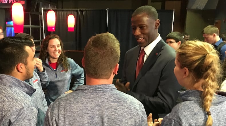 Dayton’s Anthony Grant talks to fans from the Red Scare student section on April 1, 2017, at UD Arena. David Jablonski/Staff