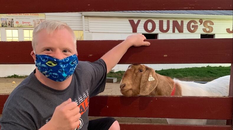 Beavercreek resident Matthew Dorn visits the farm animals on a visit to Young's Jersey Dairy in Yellow Springs.
