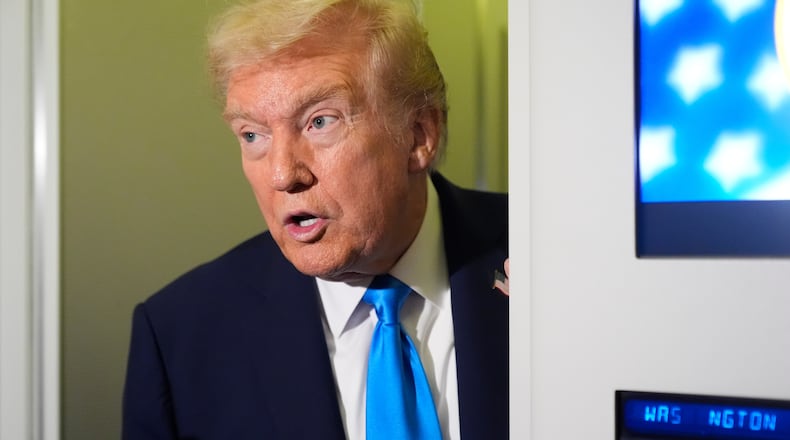 President Donald Trump speaks with reporters aboard Air Force One at Al Udeid Air Base in Doha, Qatar, Saturday, Oct. 25, 2025. (AP Photo/Mark Schiefelbein)