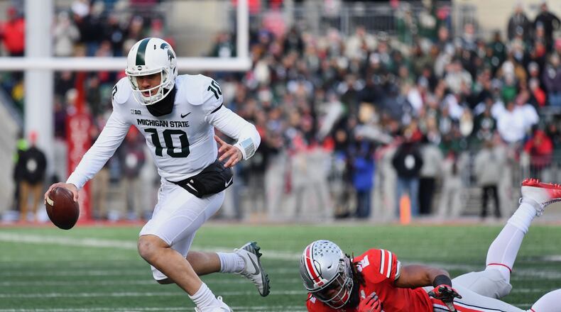 COLUMBUS, OH - NOVEMBER 11: Quarterback Messiah deWeaver #10 of the Michigan State Spartans is tripped up on fourth down by Chase Young #2 of the Ohio State Buckeyes in the fourth quarter at Ohio Stadium on November 11, 2017 in Columbus, Ohio. Ohio State defeated Michigan State 48-3. (Photo by Jamie Sabau/Getty Images)