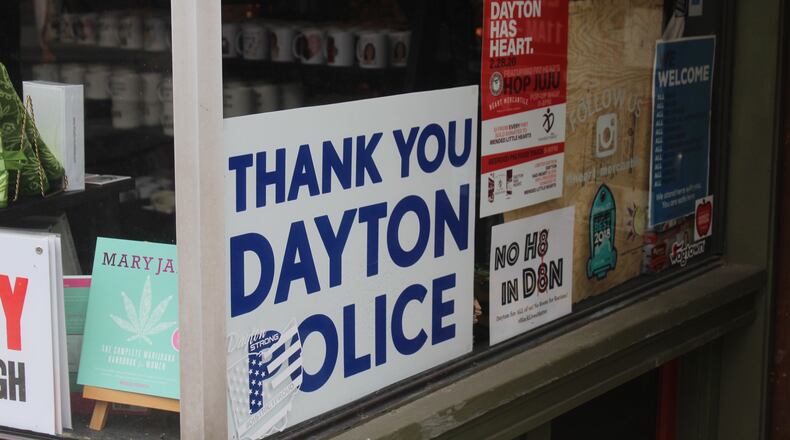 Six months after a 24-year-old Bellbrook man killed nine people in the Oregon District during the worst mass shooting in Ohio history, literal signs of strength, appreciation, resilience and the determination to “do something” about gun violence can be found throughout the historic neighborhood. Heart Mercantile displays a "Thank you Dayton Police" sign. AMELIA ROBINSON/STAFF