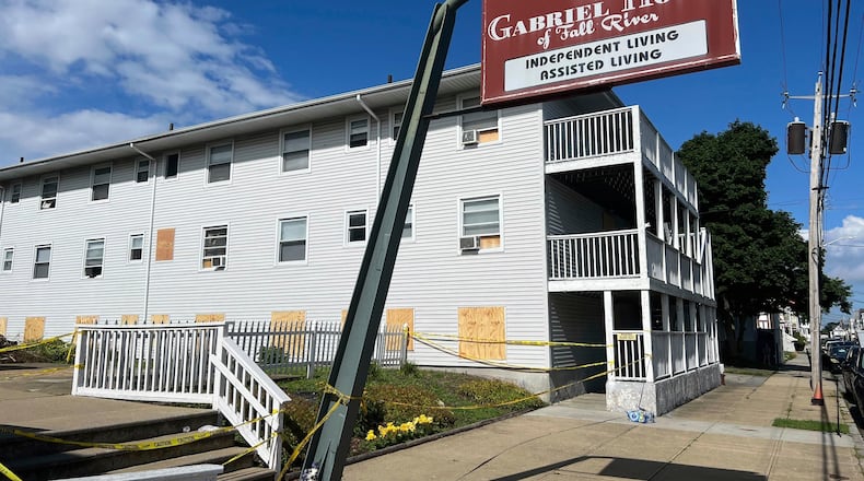 FILE - Boards cover the windows of the Gabriel House assisted living facility, where a fire killed multiple people, July 15, 2025, in Fall River, Mass. (AP Photo/Kimberlee Kruesi, File)