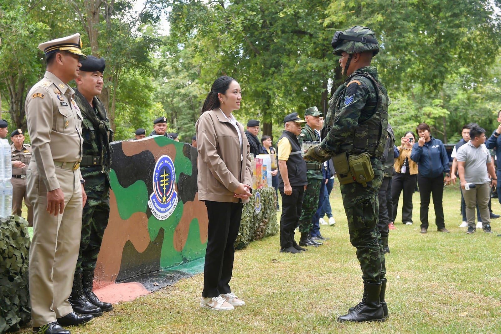 In this photo released by Thailand's Government Spokesman Office, Thailand's Prime Minister Paetongtarn Shinawatra, center, talks to a Thai soldier in Sa Kaeo Province, Thailand, Thursday, June 26, 2025.(Thailand's Government Spokesman Office via AP)