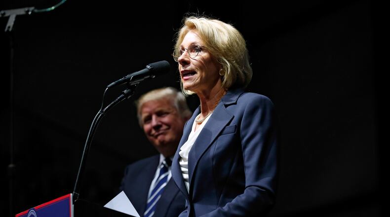 Betsy DeVos, Donald Trump’s nominee for secretary of education, speaks while on stage with the President-elect at a rally in Grand Rapids, Mich., Dec. 9, 2016. Issues related to DeVos’s wealth, power and influence with lawmakers and stance towards teachers unions and the LGBT community swirl around her nomination. (Doug Mills/The New York Times)