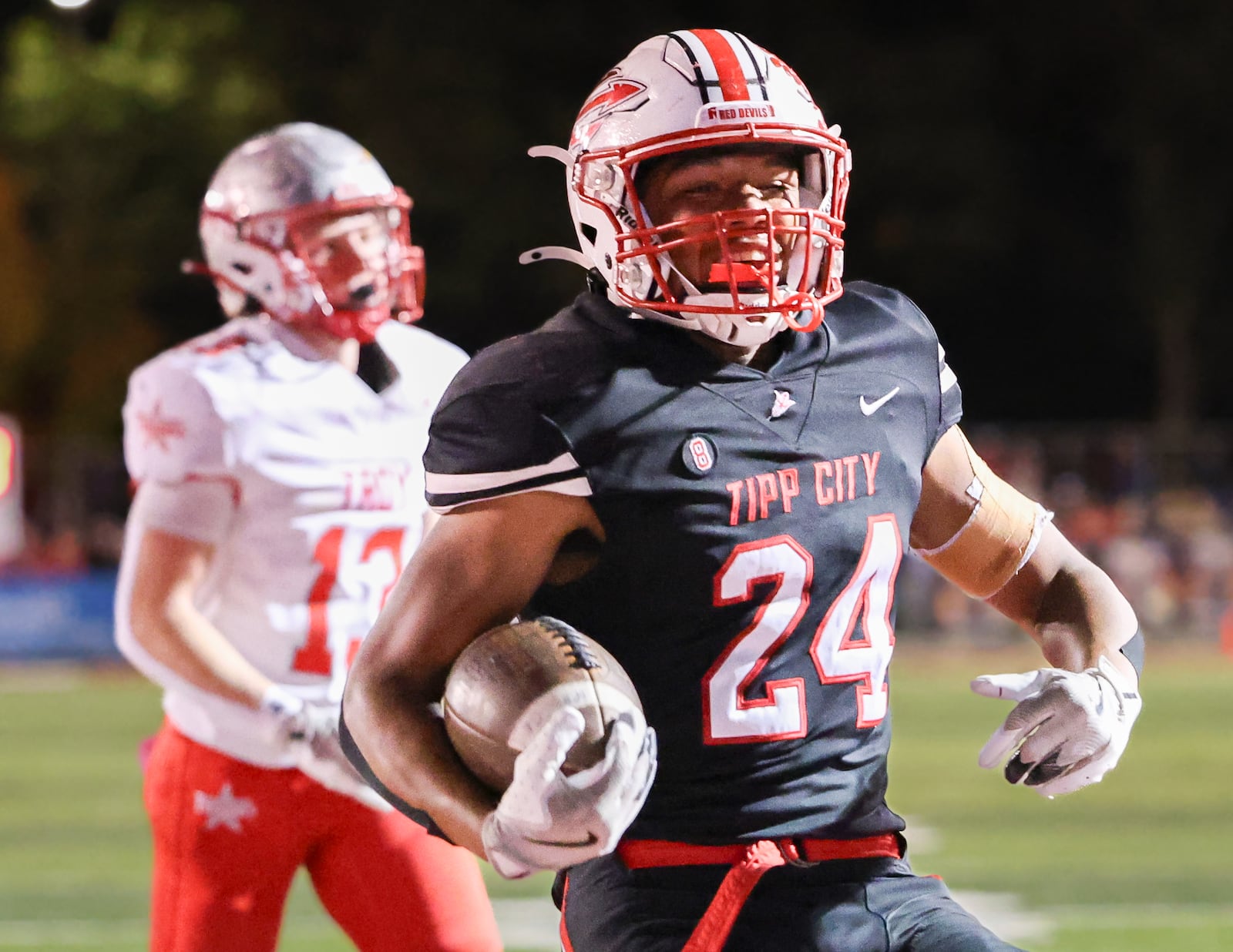 Tippecanoe senior running back Xavier Melton scores on a 5-yard touchdown run in the third quarter of a Miami Valley League game against Tippecanoe on Friday, Oct. 17 at Tipp City Park. Melton scored two touchdowns in the Red Devils' 21-0 win. BRYANT BILLING / STAFF