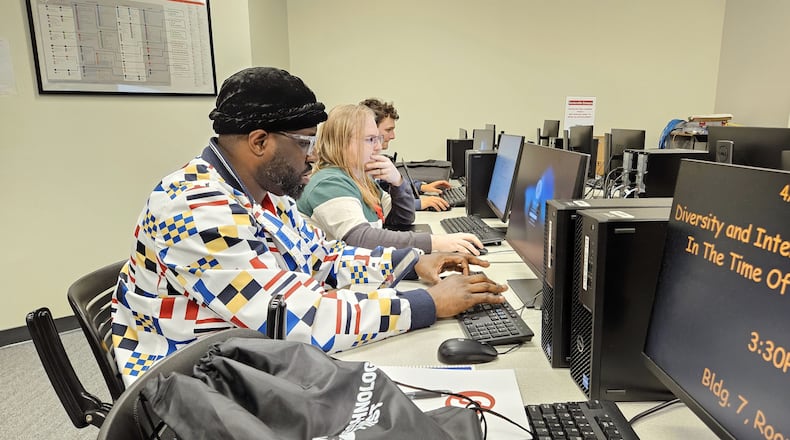 Sinclair Community College computer science students Ayodele Ogunsakin, Spencer McNally, and Louis Jahnigen work on data analysis in the Centerville campus labs. Contributed