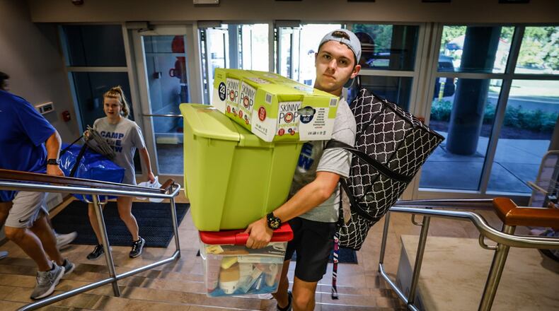 University of Dayton freshman Christos Bird, from Michigan, carries his stuff to his dorm room at Stuart Hall Friday August 18, 2023. UD enrollment remains high this year, with more than 11,000 undergraduates, graduate, doctoral and law students. JIM NOELKER/STAFF