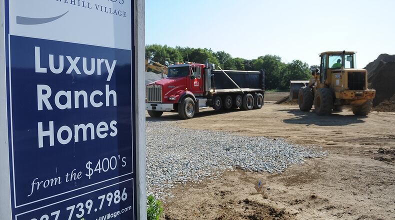 Heavy equipment moves dirt at the site of The Courtyards at Stone Hill Village on Trebein Rd. in Beavercreek Twp. MARSHALL GORBY\STAFF