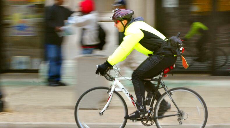 Ned Pennock rides his bike from his home in Centerville to his downtown job in all kinds of weather. He passes the Arcade on his way to work on Third Street. FILE.