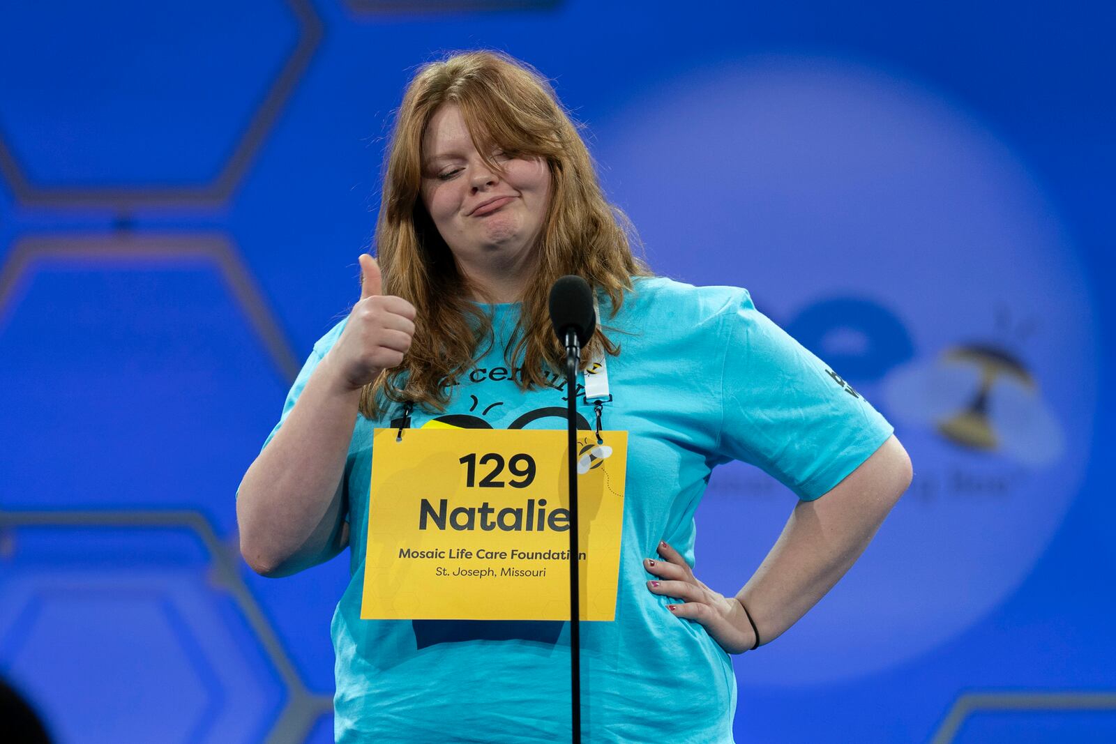 Natalie Mae Linthicum, 13, of St. Joseph, Mo.,gestures as she spells her word as she competes during the first preliminary round of the Scripps National Spelling Bee at the Gaylord National Resort & Convention Center, Tuesday, May 27, 2025, in Oxon Hill, Md. (AP Photo/Jose Luis Magana)