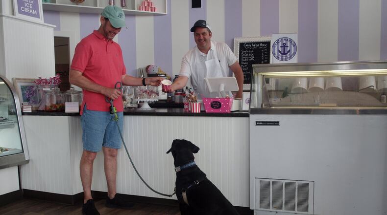 Teddy waiting patiently for his dad to get his ice cream from Erik Berakovich, the owner of Candy Harbor. KARIN SPICER