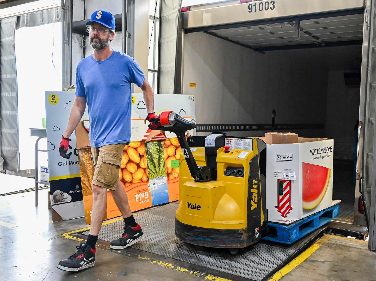 Craig Burns, an employee of Foodbank Inc., unloads a skid of watermelons on Wednesday, July 9. Thousands of Ohioians could lose elgibility for food assistance over the next few years under the new federal budget. BRYANT BILLING / STAFF