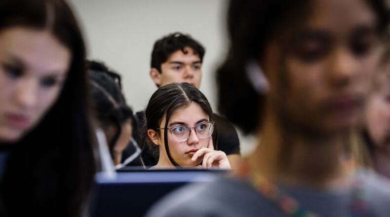 Wright State University freshman Madelyn Schoenberger listens to sociology professor, Chigon Kim, during a class. The U.S. Department of Education announced Tuesday that officials completed reprocessing FAFSA forms impacted by known issues with IRS data, which should enable all universities and colleges to package financial aid offers. JIM NOELKER/STAFF PHOTO