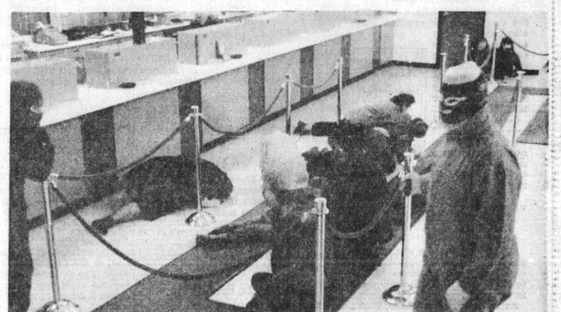 Masked robbers guard customers at Winter's Bank, Patterson Road branch in March 1975. DAYTON DAILY NEWS ARCHIVES